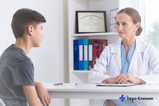Подросток сидит на консультации у врача